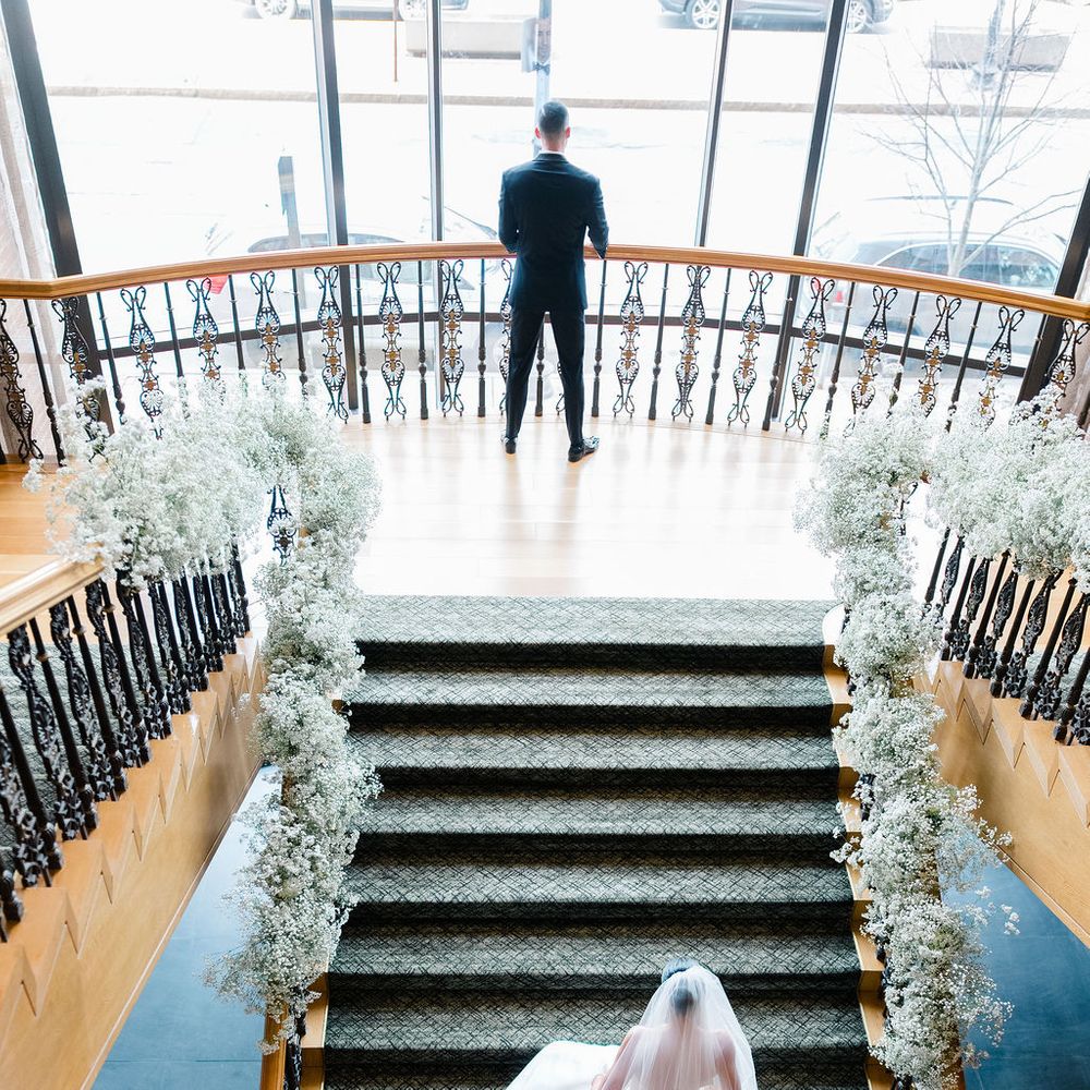 bride walking up grand staircase for first look