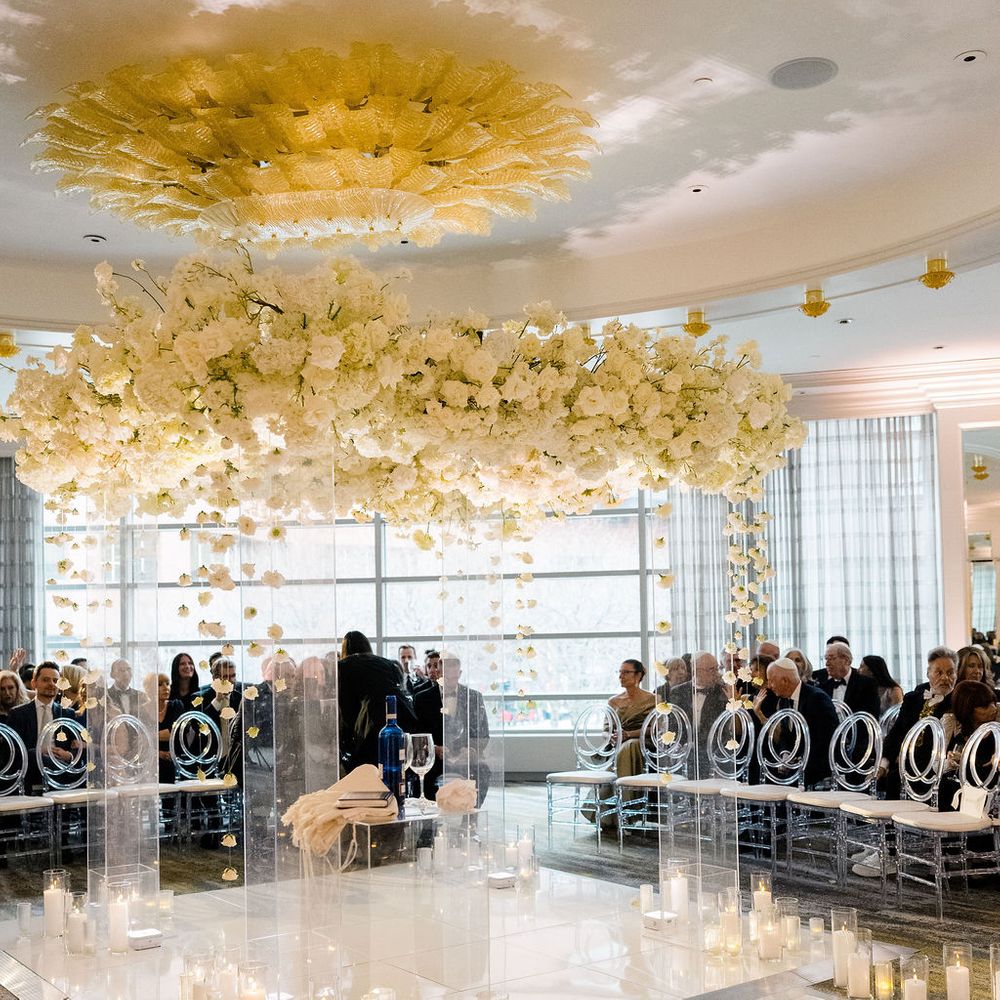 candlelit floral glass arch circled seating ceremony