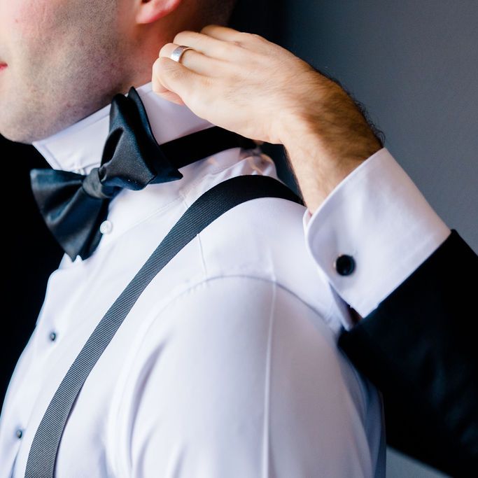 groom getting ready sleek black bow tie