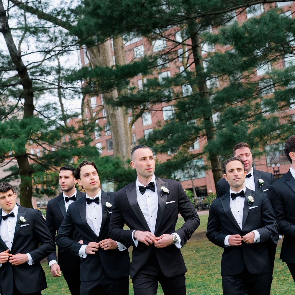 groomsmen buttoning suits groomsmen poses