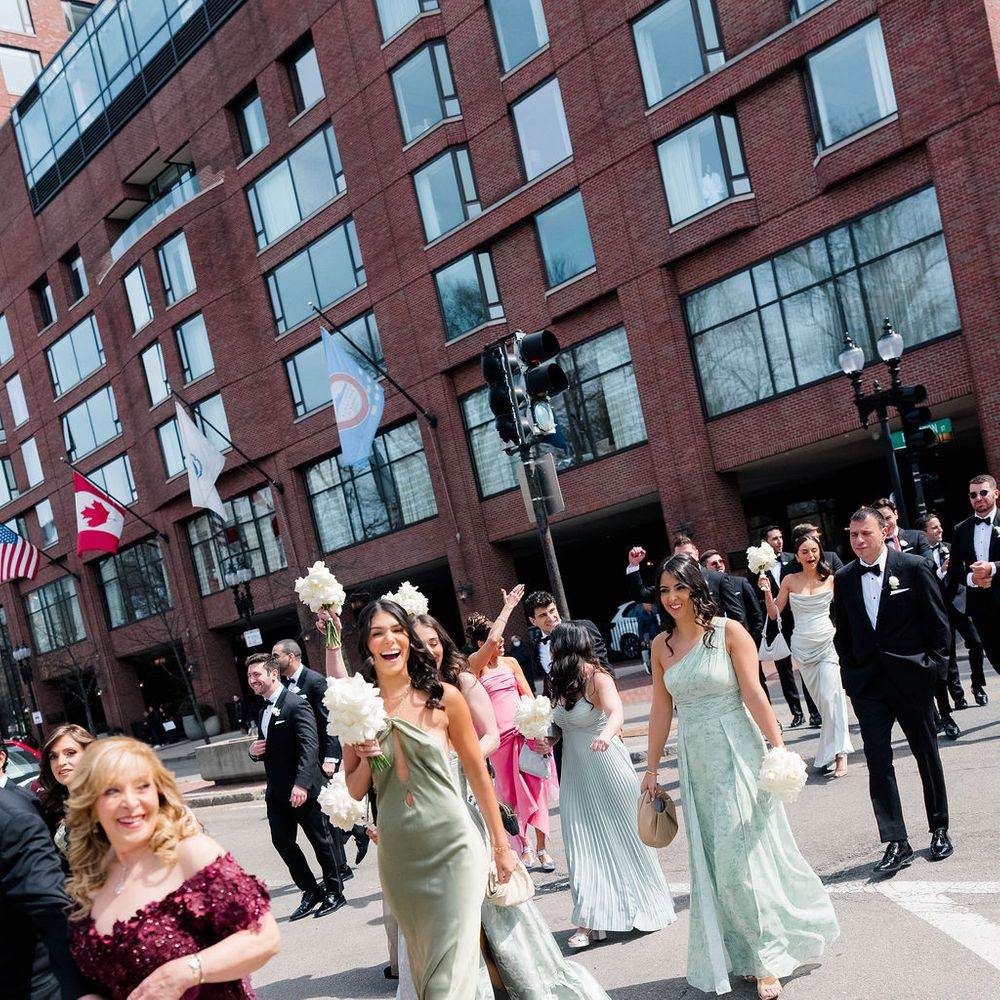 wedding party crossing road on way to wedding