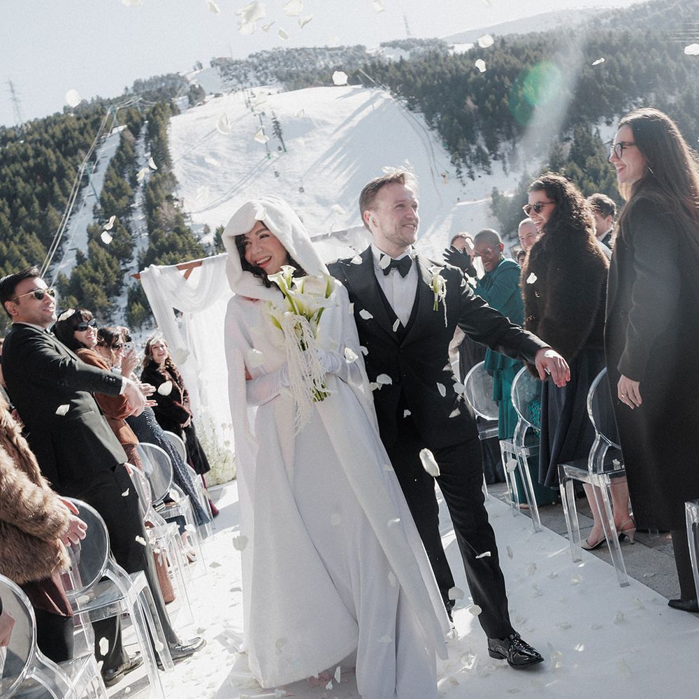 snowy mountain wedding confetti exit modern winter bride