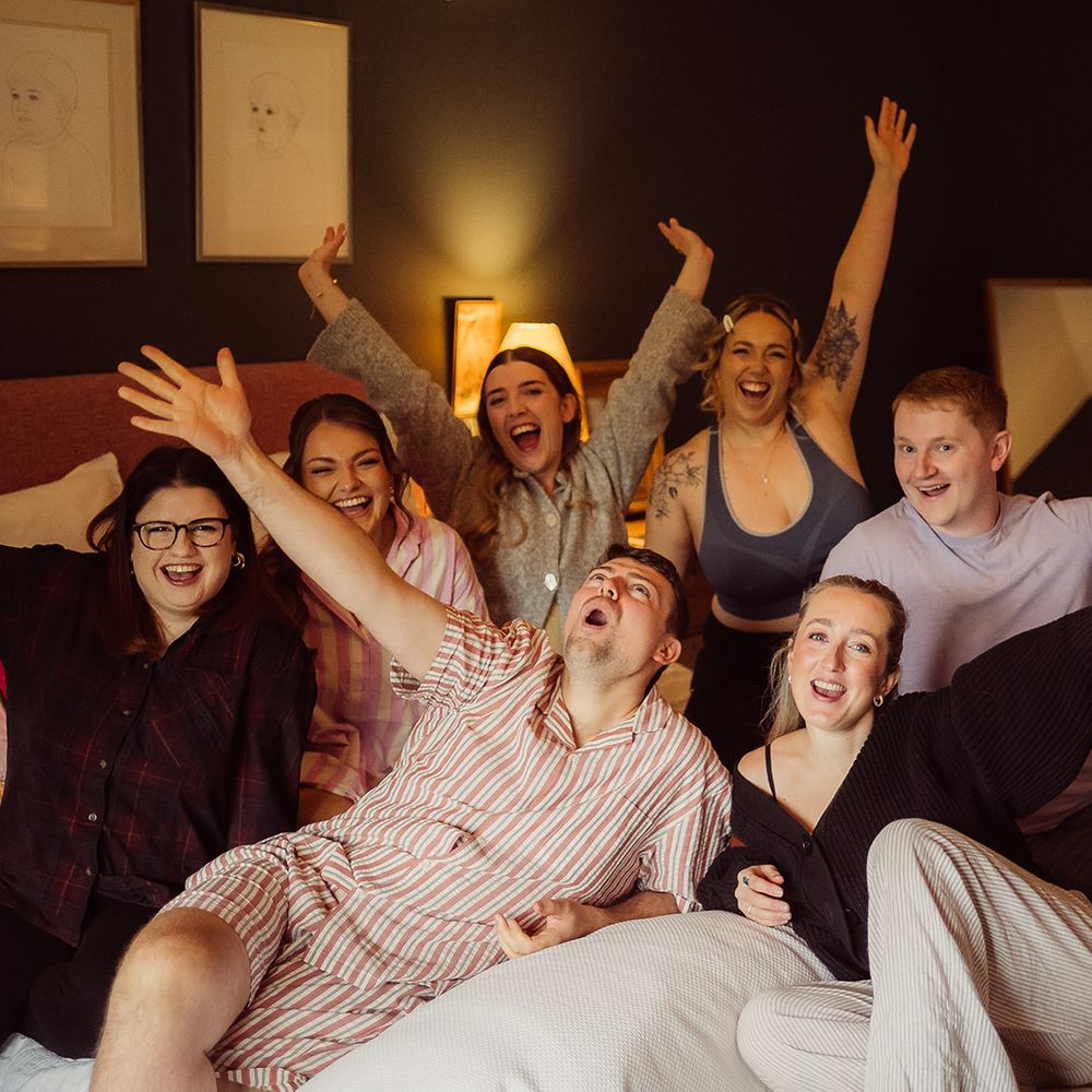 groom bridesmaids getting ready on hotel bed