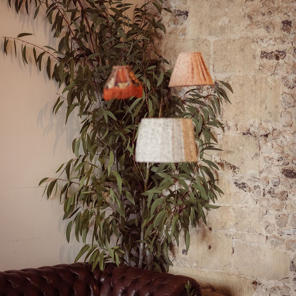 leather sofa greenery hanging lampshade decor