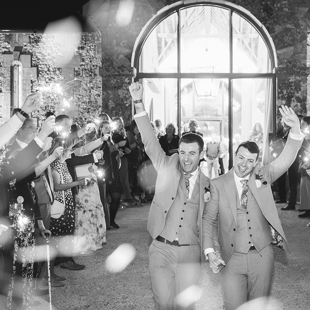 sparkler exit grooms hands in air