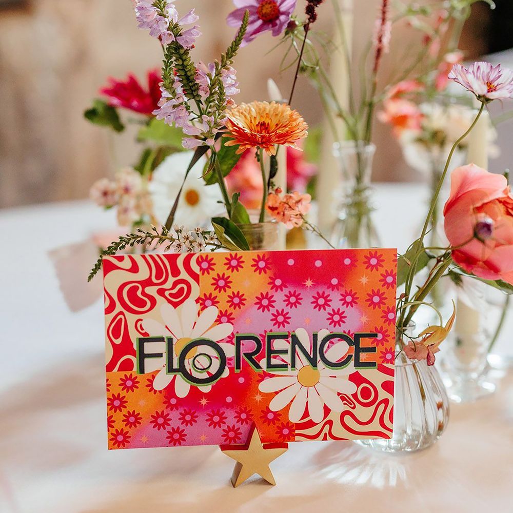 Bright and funky pattered table name sign in pink and orange