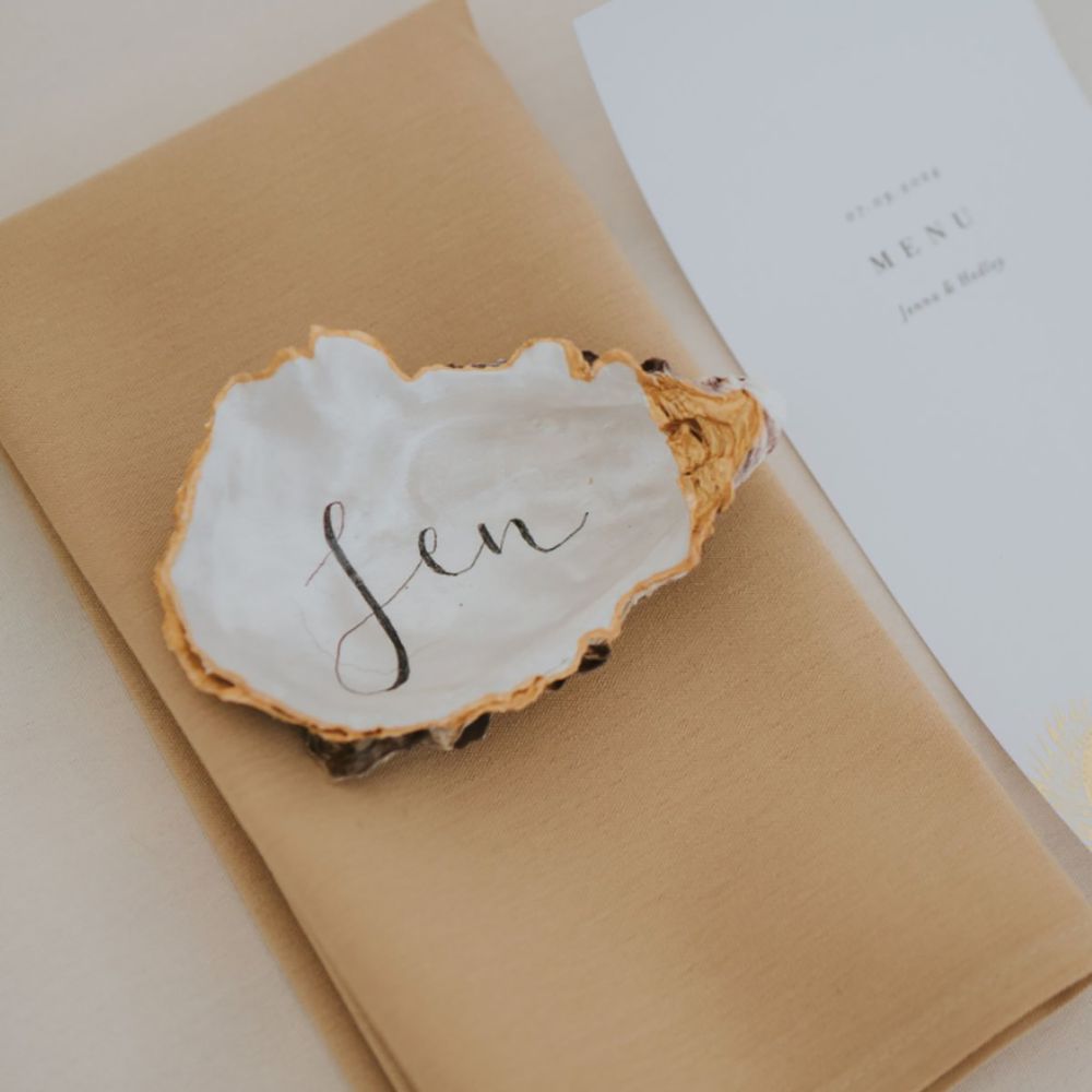 Coastal wedding with seashell place names with gold detailing