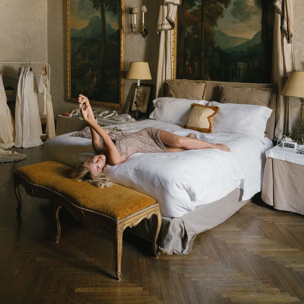 bride laying in elegant gold bed