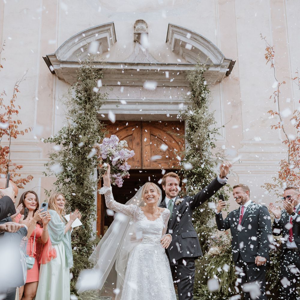 bride and groom showered in white confetti Italian wedding