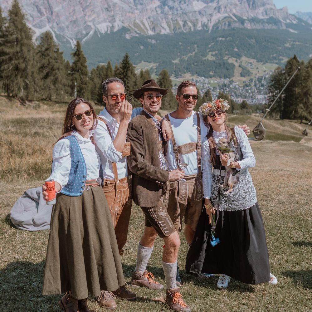guests dressed in italian lederhosen in dolomites mountain wedding