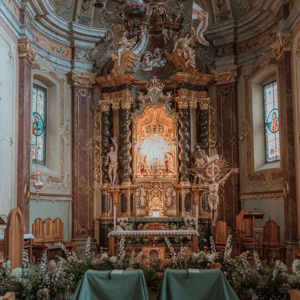 traditional italian church wedding green arm chairs surrounded by forest flowers