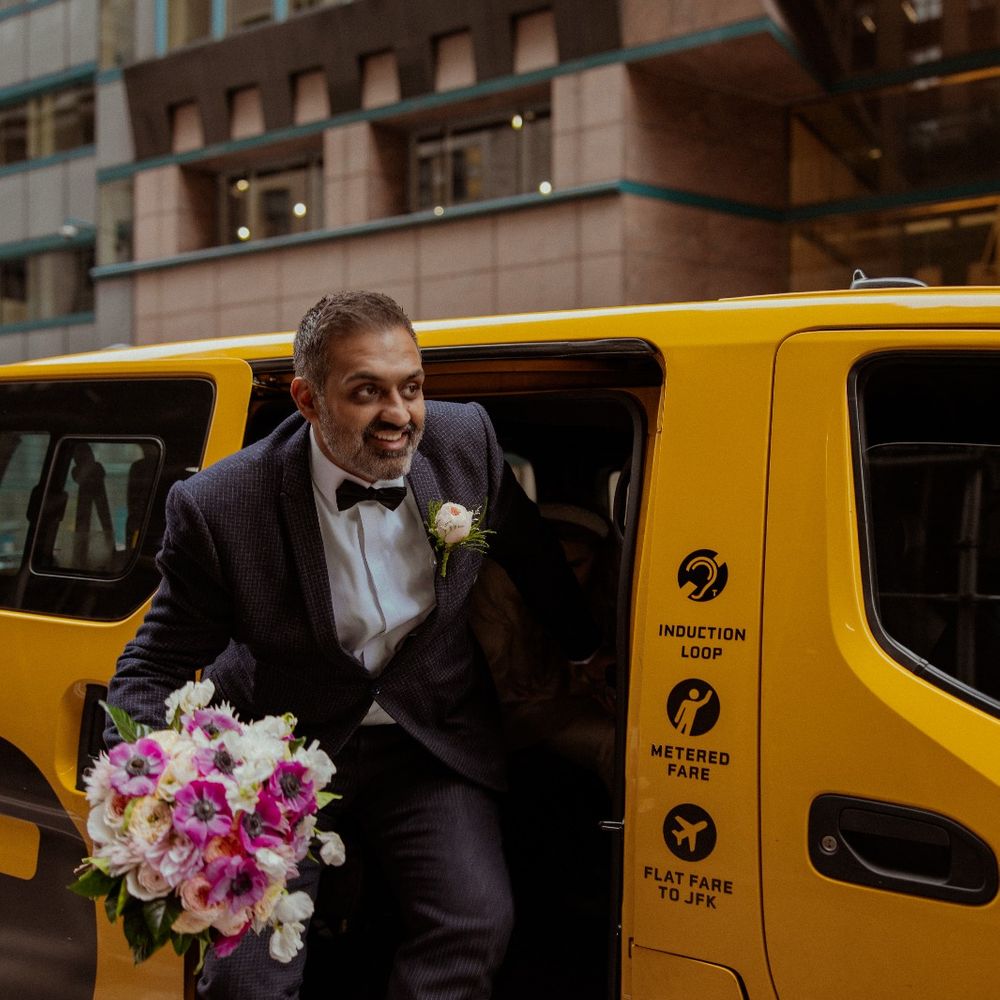 groom getting out of yellow new york taxi