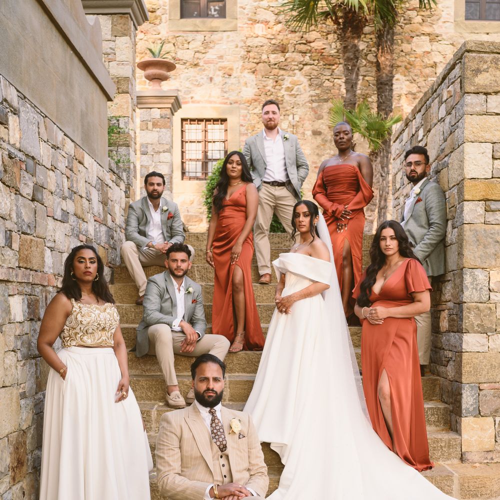 Family wedding group photo with guests seated or stood at different heights