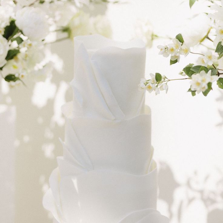 All White Luxe Classic Wedding Cake Surrounded by Flowers