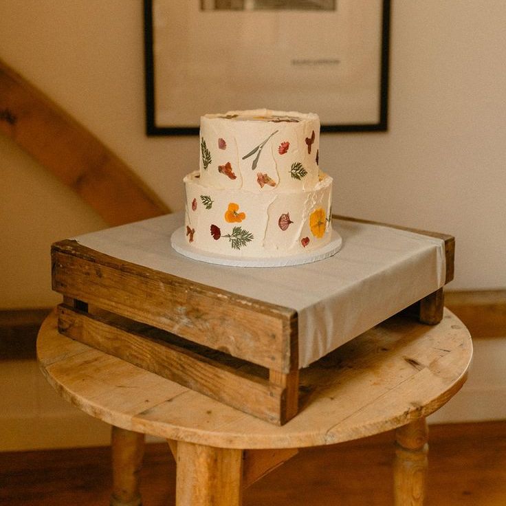 Minimal Two Tier White Frosted Buttercream Wedding Cake & Pressed Flower Decoration at Boho Wedding