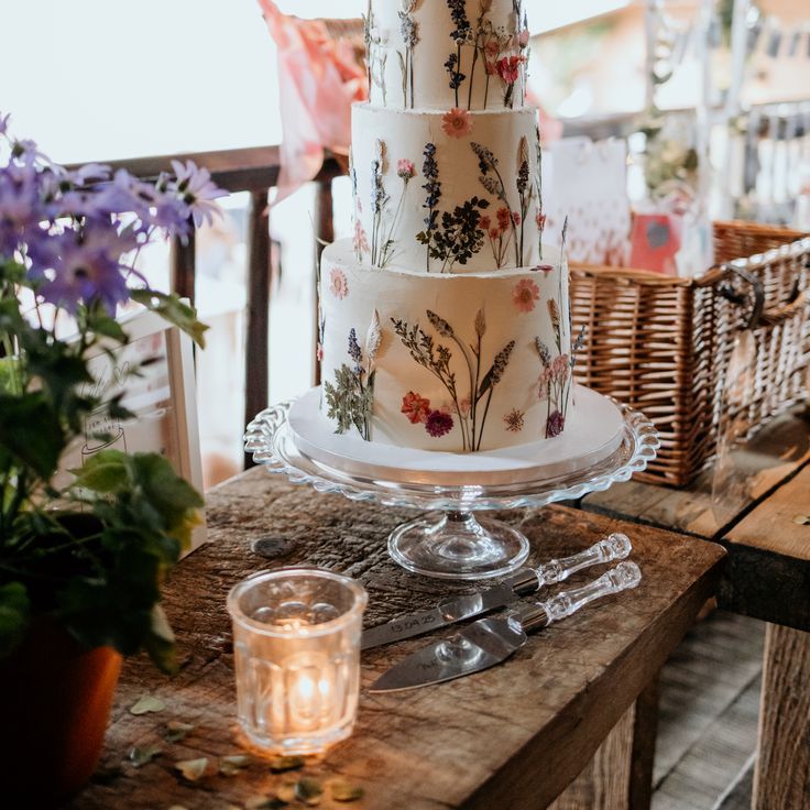 Three Tier White Iced Wedding Cake With Pressed Wildflowers