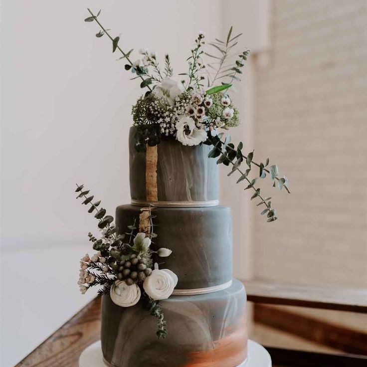 Three Tiered Wedding Cake With Ombre Cool Toned Grey Icing On Stone Cake Stand