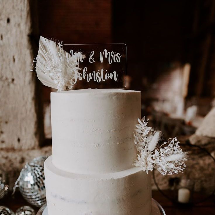 Two Tier White Frosted Wedding Cake With Acrylic Wedding Cake Topper