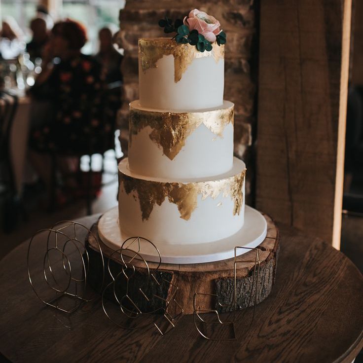 Three tier gold drip wedding cake 
