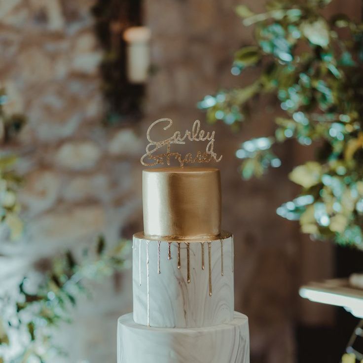 Marble and gold wedding cake with gold cake topper