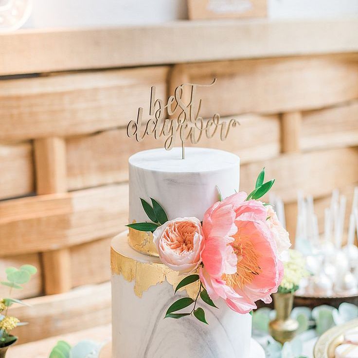 Two tiered grey marble wedding cake with pink peony and cake topper