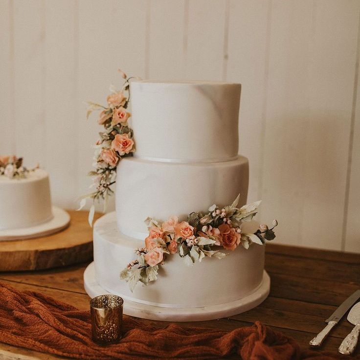 Three tier simple marble wedding cake with pink flowers
