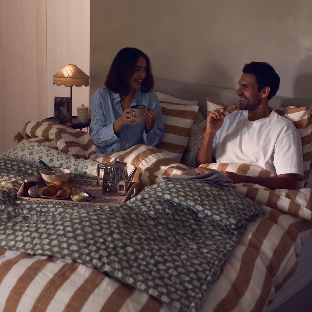 Couple having breakfast in bed