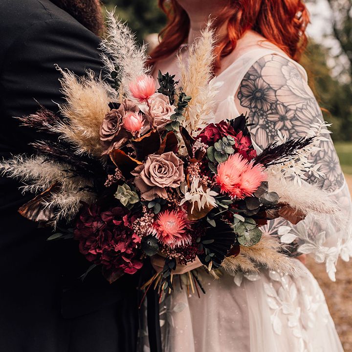 Bride carrying boho dried wedding flower bouquet