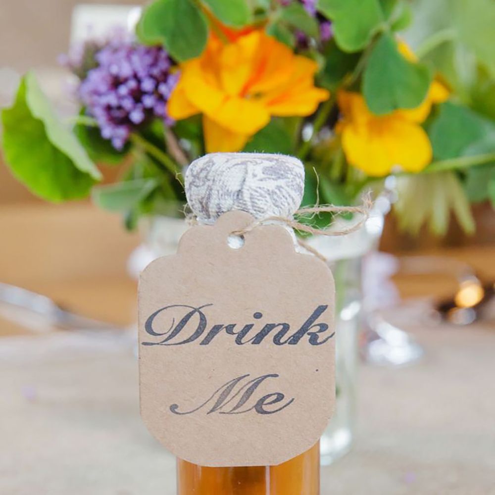 Drink wedding favour idea with 'drink me' label