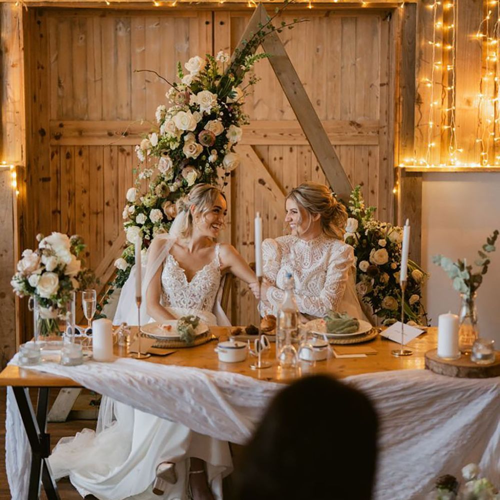 Sweetheart Table For Two Brides with Cosy Wedding Lighting