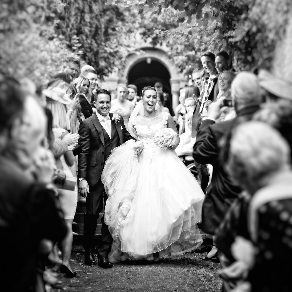 bride and groom exiting ceremony black and whiten photography
