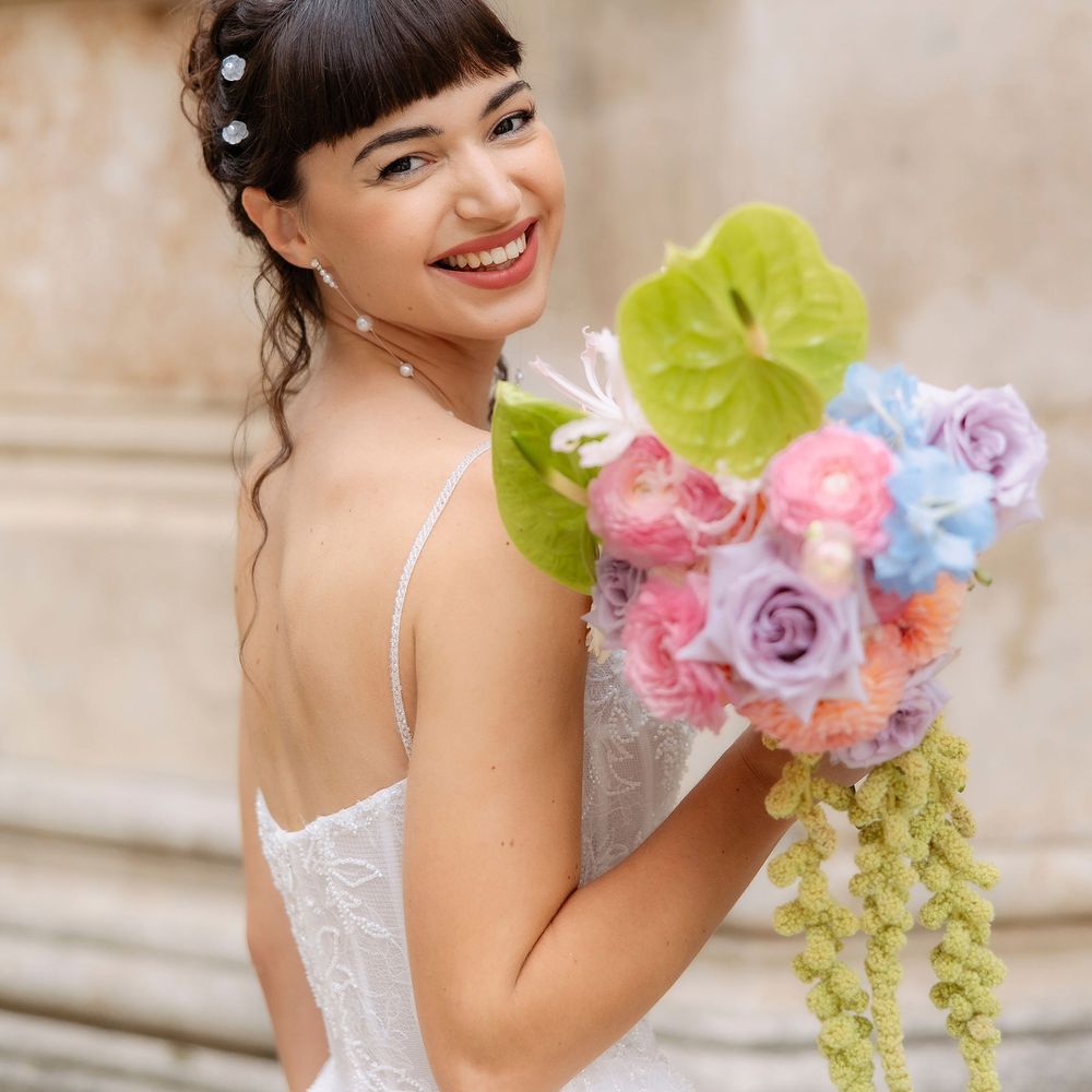 bride smiling with pastel colour bouquet