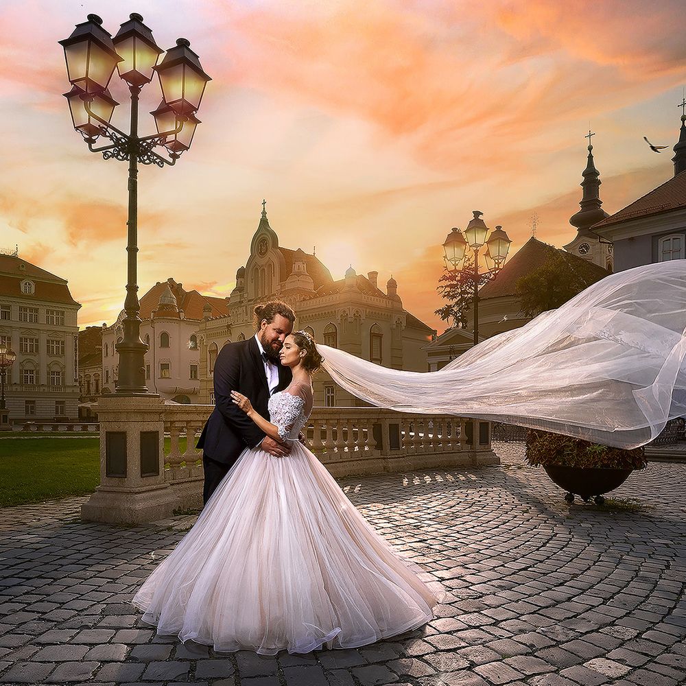 sunset married couple in courtyard veil floating in the wind