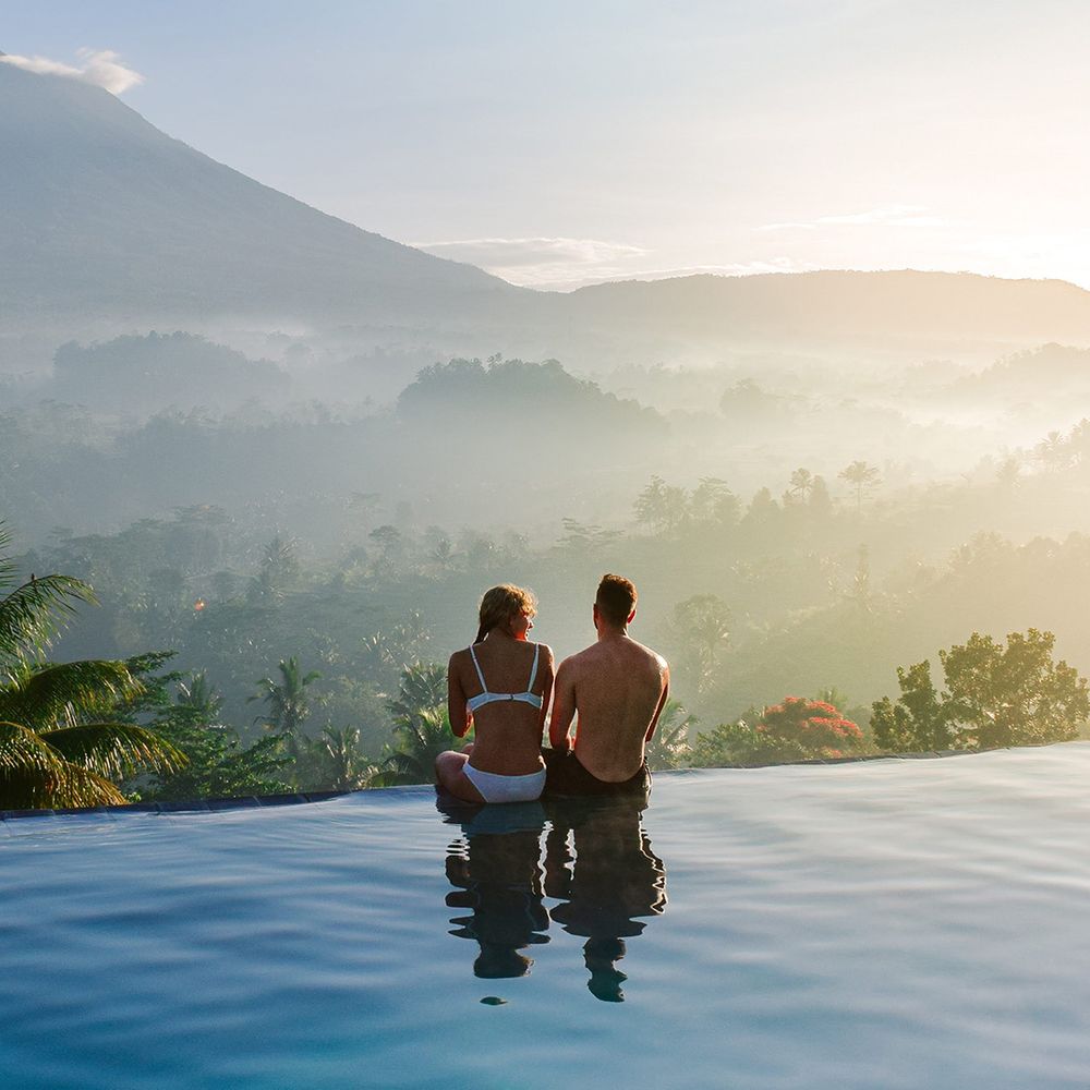 couple-sitting-on-edge-of-infinity-pool-honeymoon