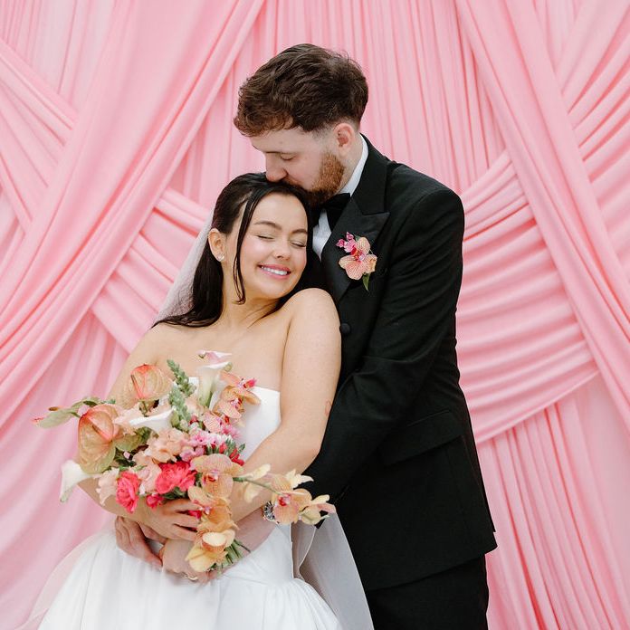 bride groom pink drapery embrace