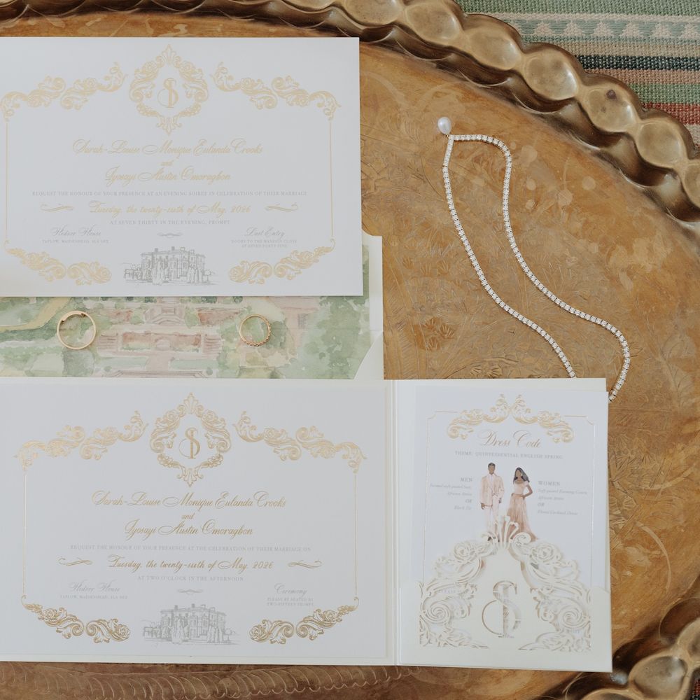 Gold foil wedding stationery suite with rings and diamond necklace on an engraved brass tray