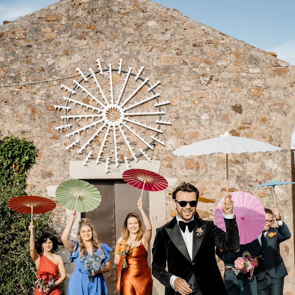 groom colourful parasols recessional