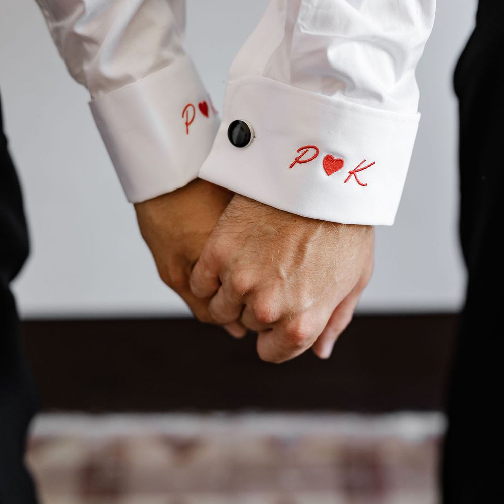 grooms clasped hands embroidered cuff detail