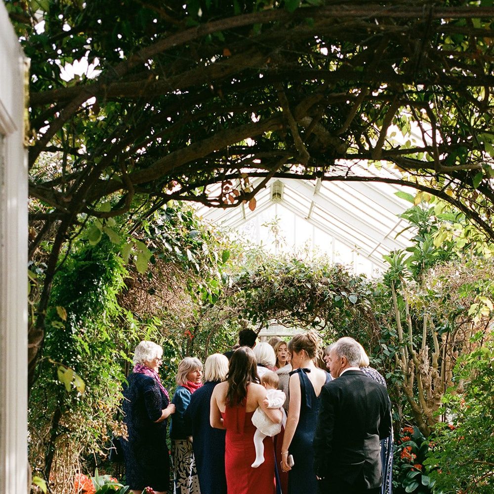 guests greenhouse walkway holding baby
