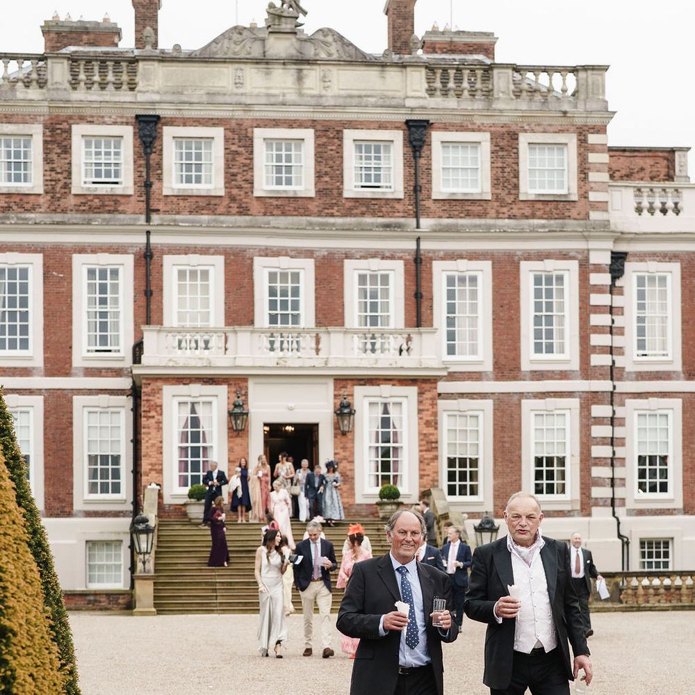 guests walking drinks country house