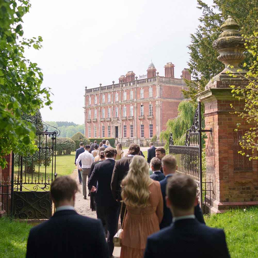 guests walking wrought iron gates