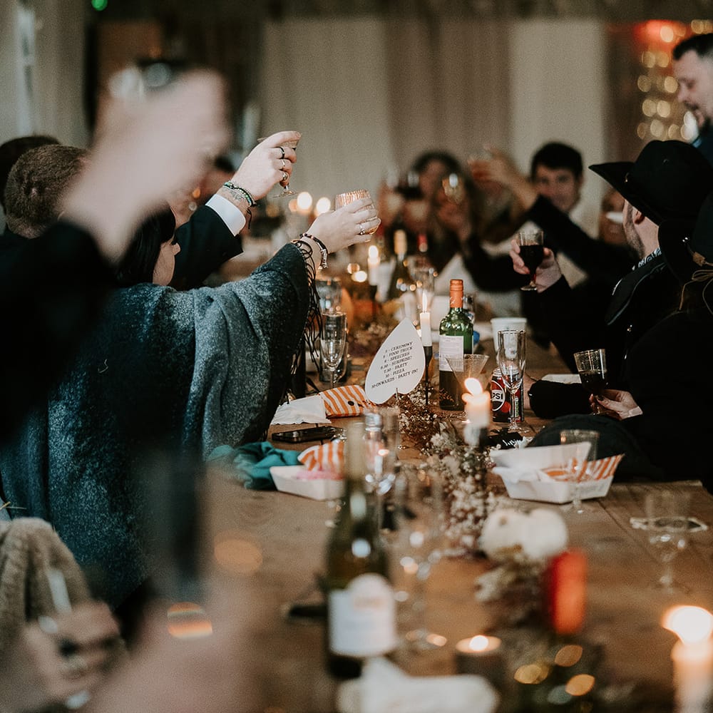 halloween reception guests raising glasses
