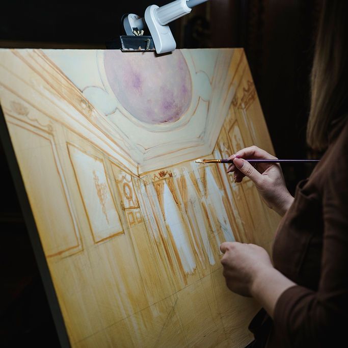 Artist painting a domed interior scene on canvas at an easel with a brush