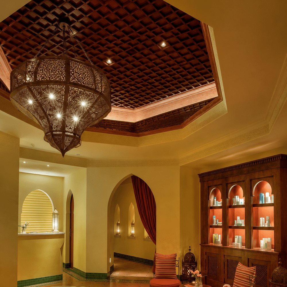 Luxury spa reception with Moroccan-inspired décor, relaxing lounge and tranquil water feature.