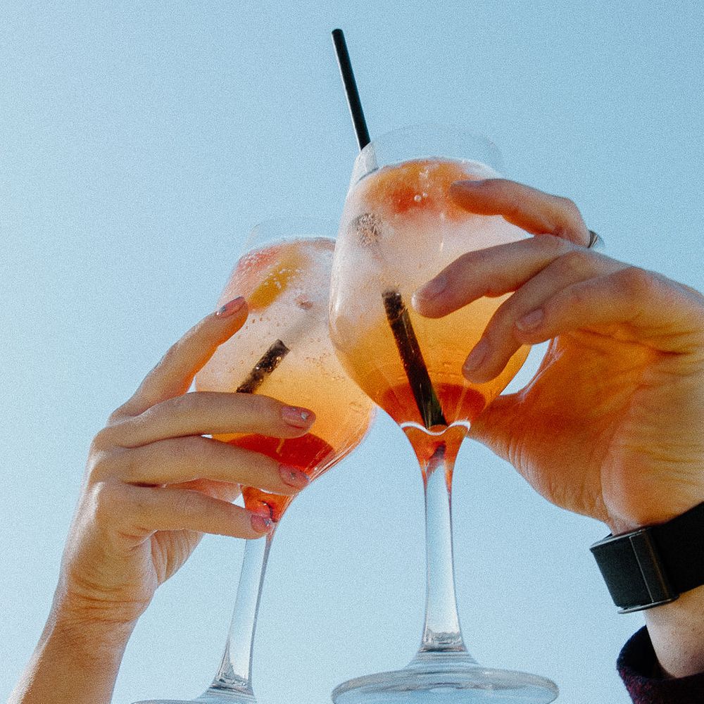 orange aperol spritzes toast blue sky