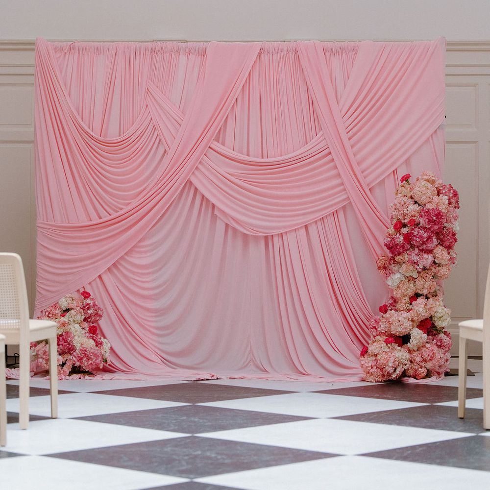 pink draped ceremony backdrop checkerboard