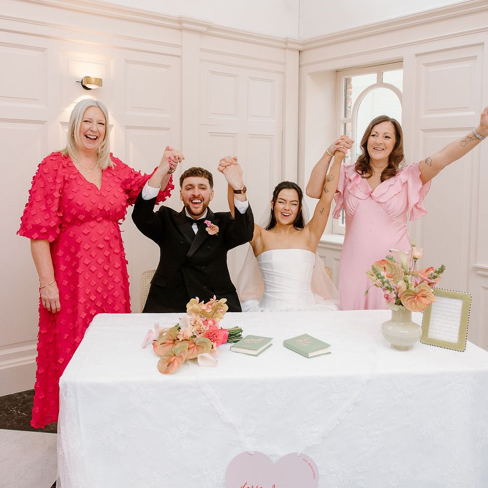 register signing arms raised celebration