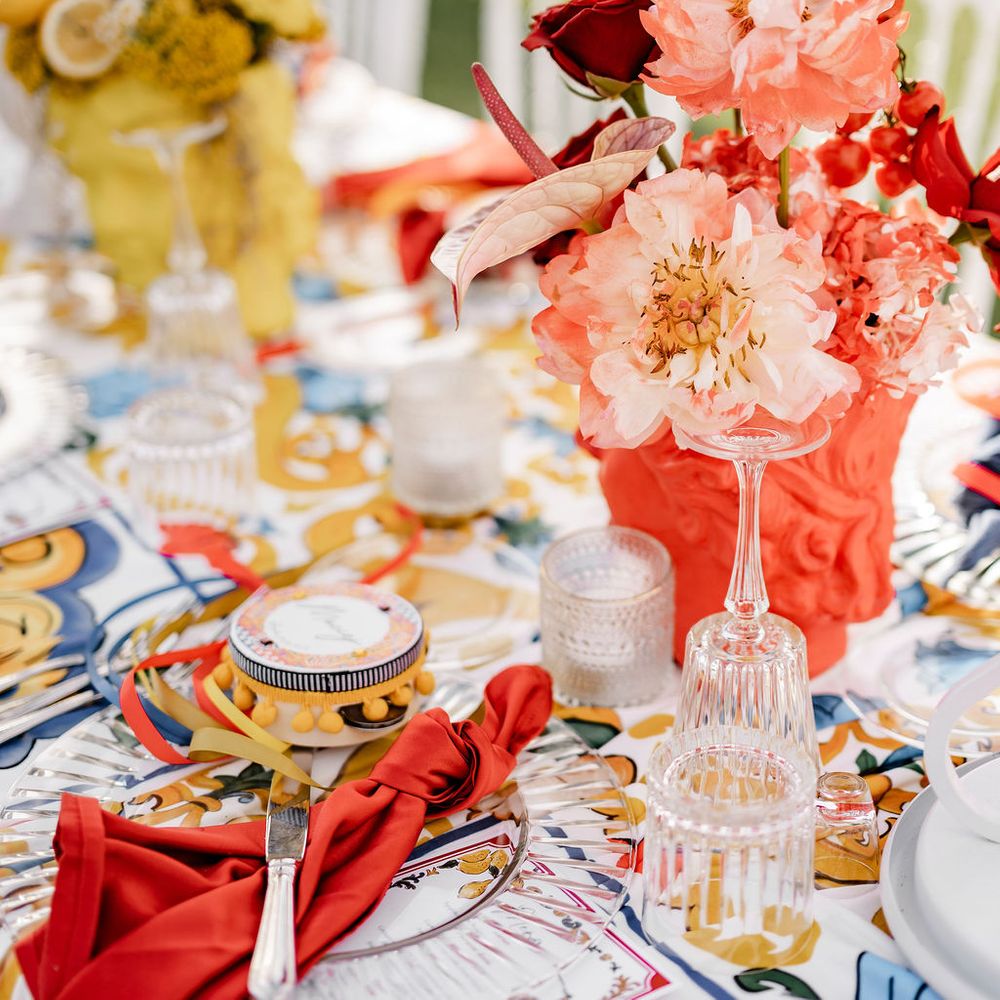 table setting red napkin peonies