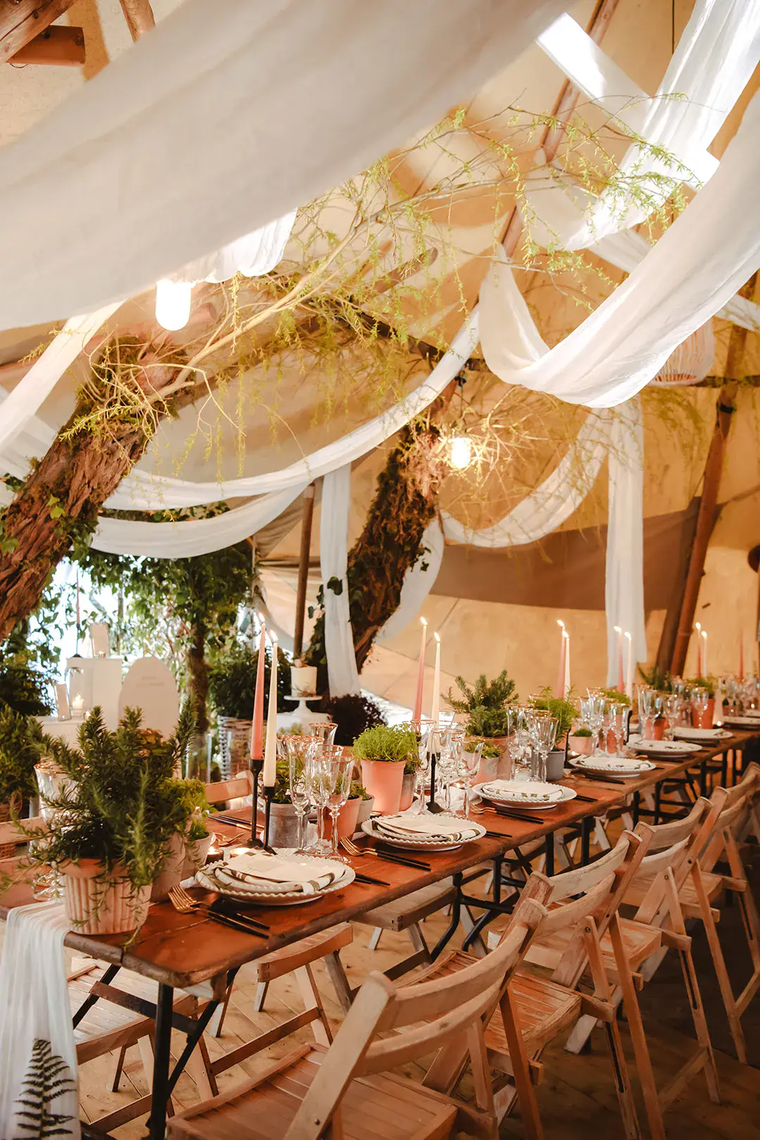 The Garden Tipi wedding with white drapery and foliage for eco-friendly wedding decor 