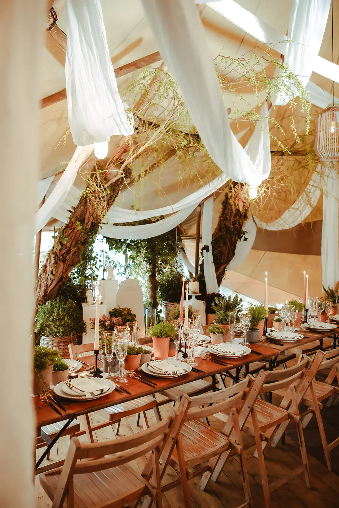 Eco-friendly sustainable wedding decor with drapery including peach and grey taper candles for the table decorations 